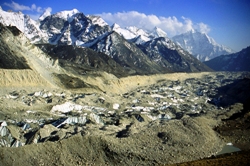 Fig. 4. One of many Himalayan glaciers losing mass, Khumbu Glacier, Nepal. The uneven glacier surface mantled by debris. Substantial downwasting evident from the Little Ice Limit, defined by fresh moraine scar across middle of picture (M Hambrey)
